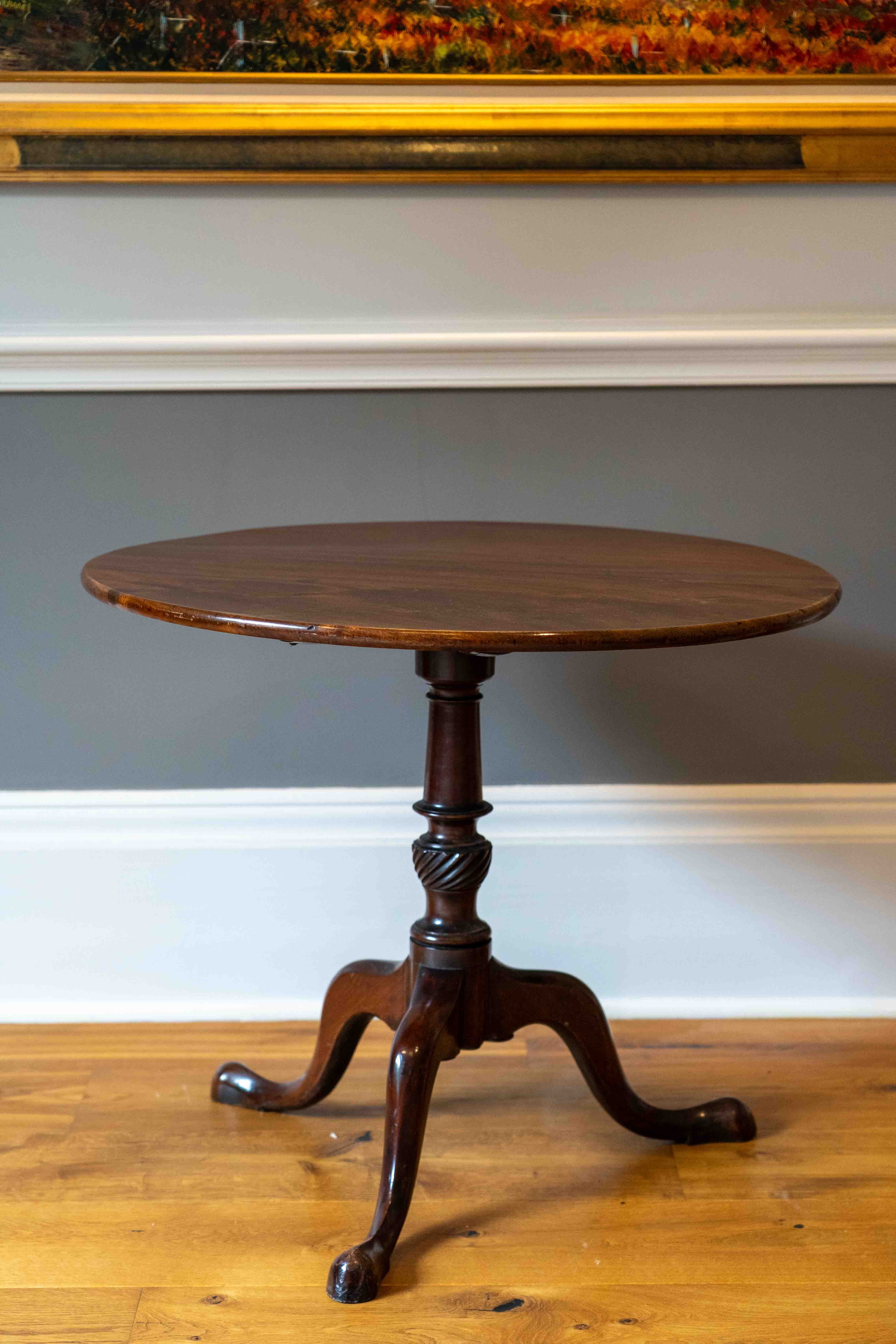 A George III circular mahogany tilt top tripod table, diameter 82cm, height 70cm. Condition - fair